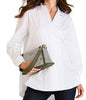 Woman holding a green and gray handbag against a white background
