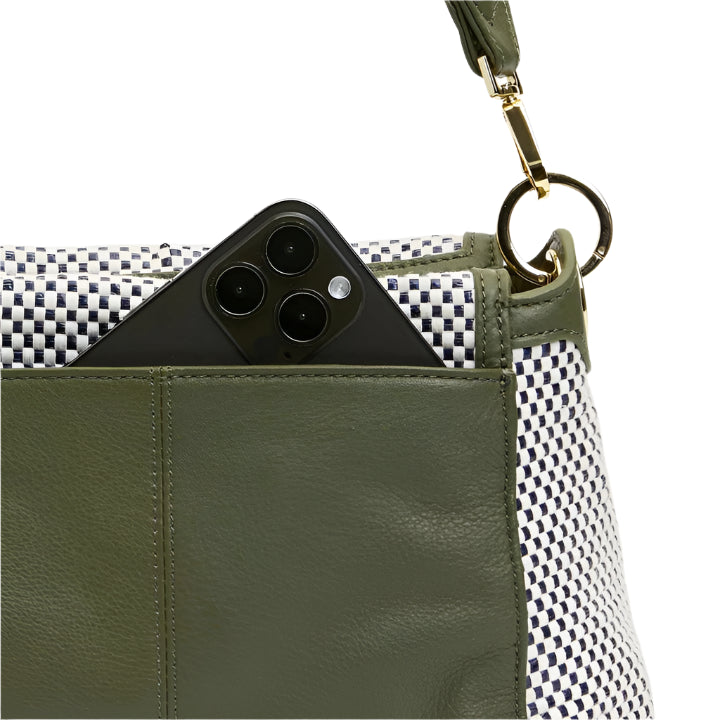 Green handbag with a phone inside, on a white background