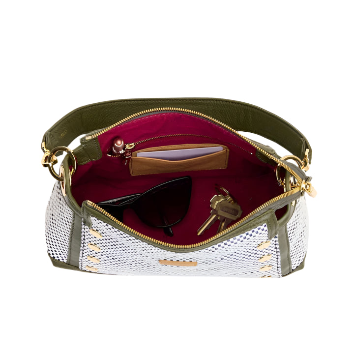 Open handbag with sunglasses and keys on a white background