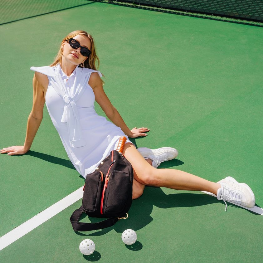 COURTSIDE SLING in Black/ Gold with Red Zip