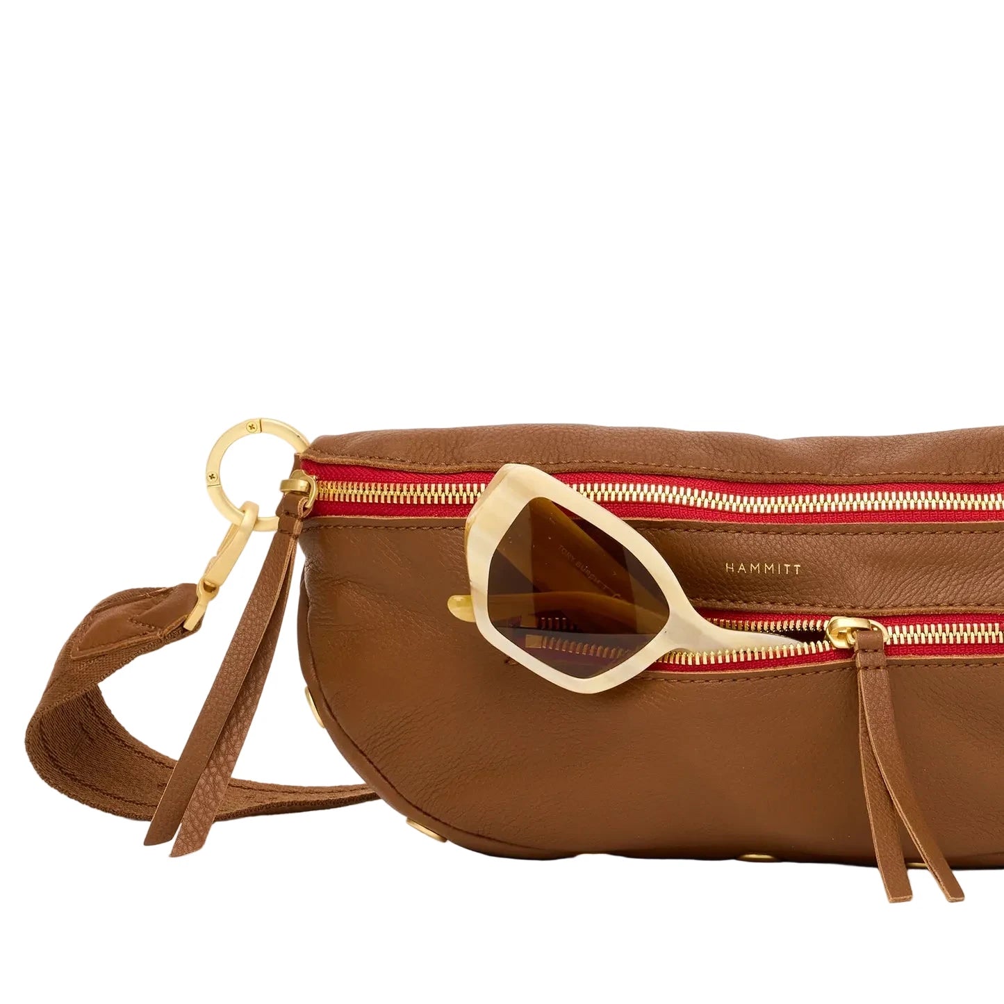 Brown leather handbag with sunglasses on a white background