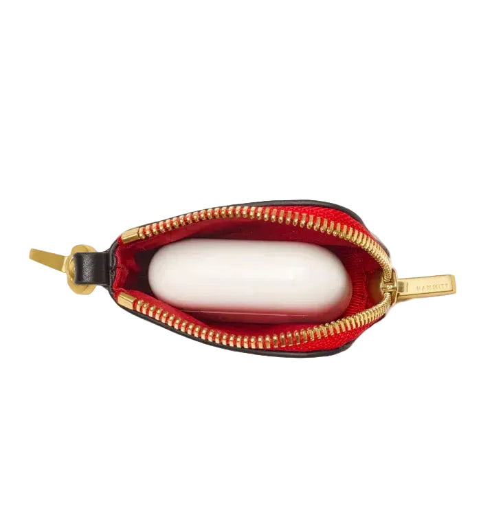 Small pouch with gold zipper and red interior on a white background