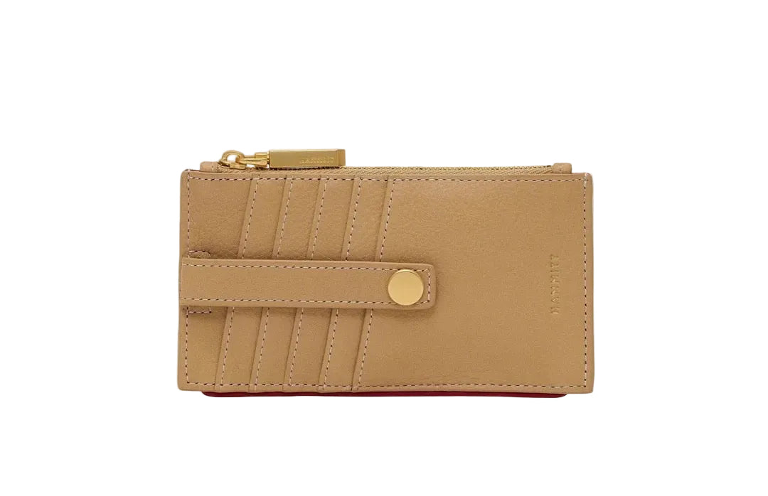 Beige wallet with a gold zipper and button on a white background