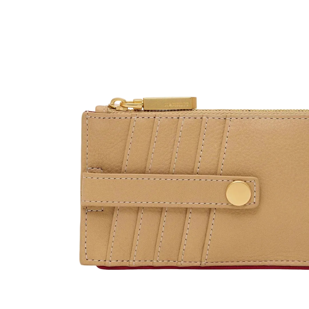 Beige wallet with gold accents on a white background