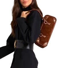 Woman wearing a black outfit with a brown leather bag over her shoulder.