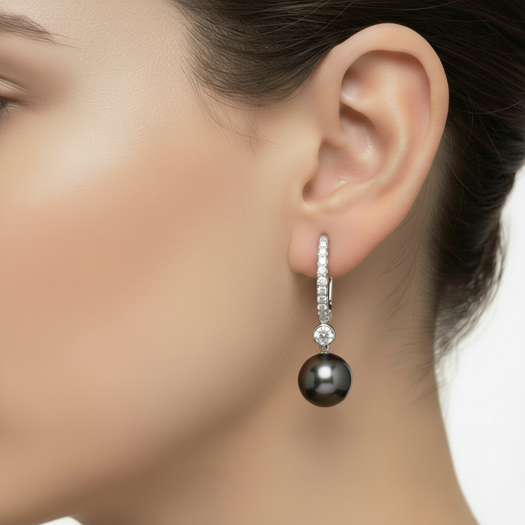 Black pearl earrings with silver and diamond accents on a white background