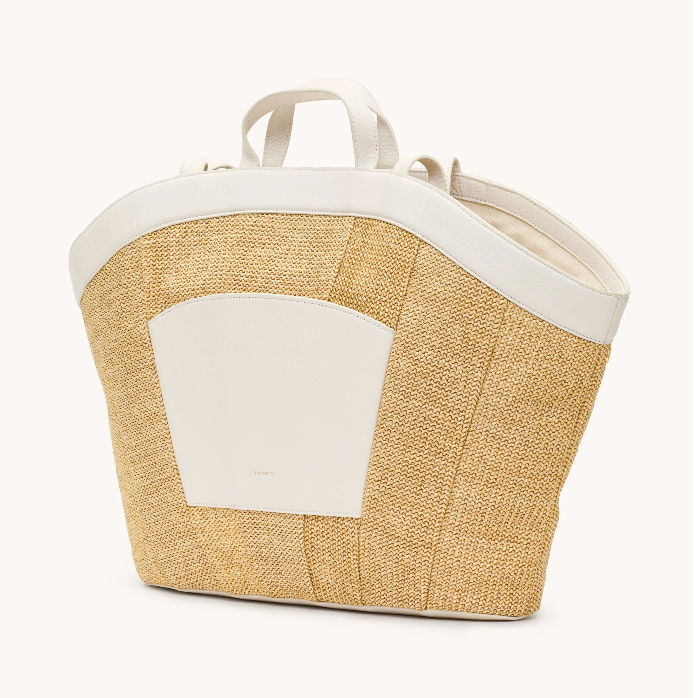Beige straw bag with white accents on a white background