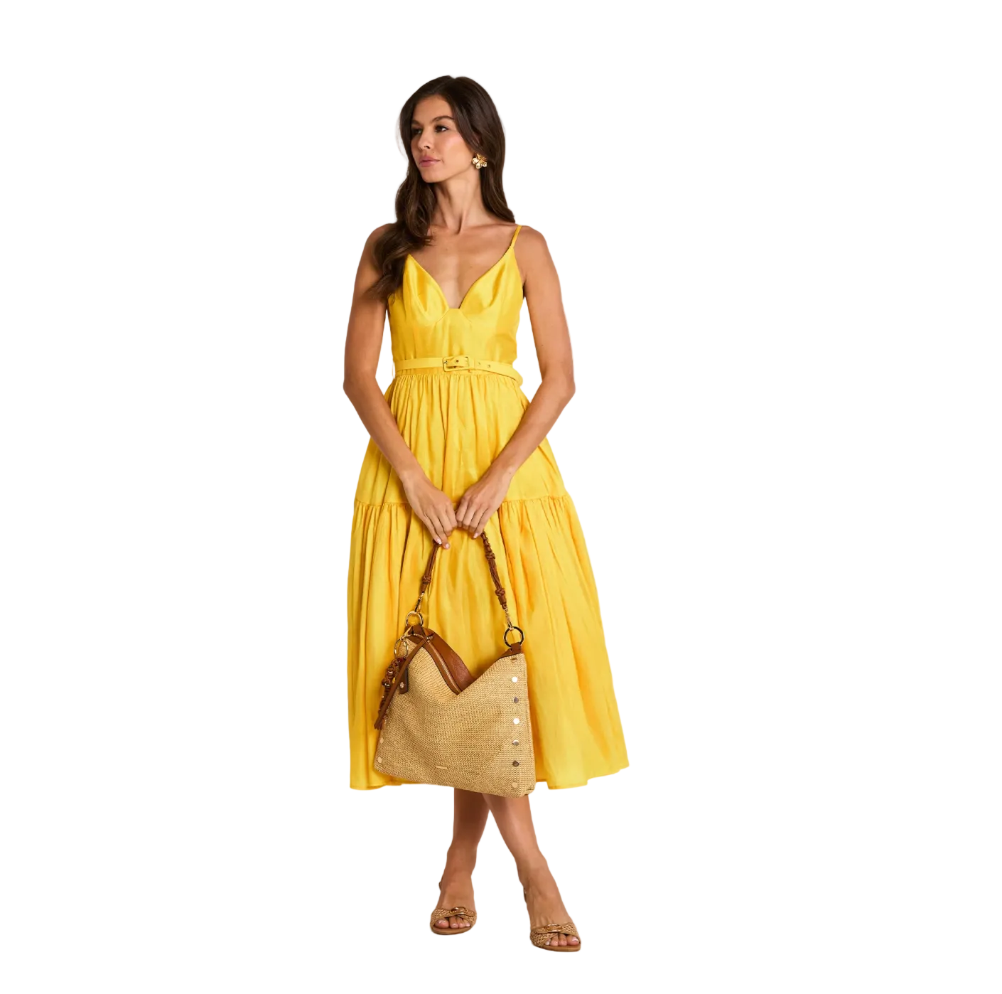 Woman wearing a yellow dress holding a straw bag on a white background