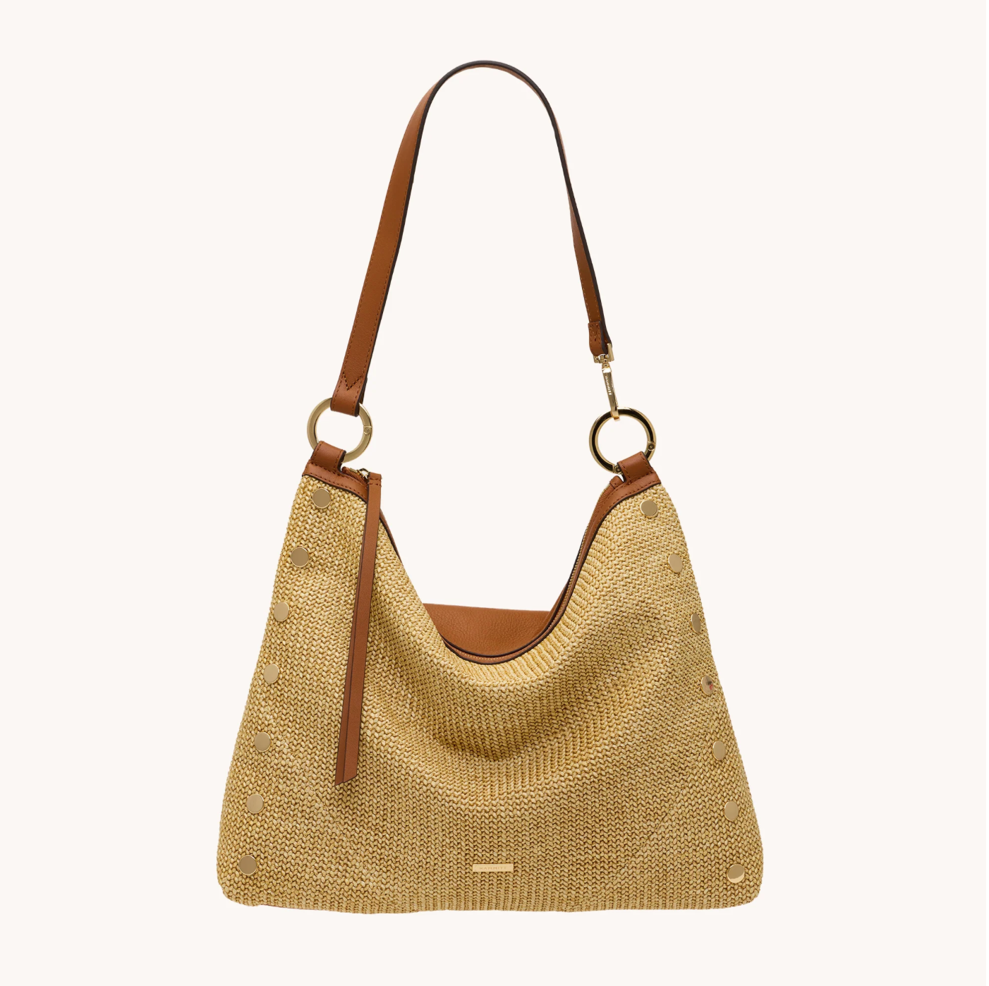 Beige straw handbag with brown leather accents on a white background