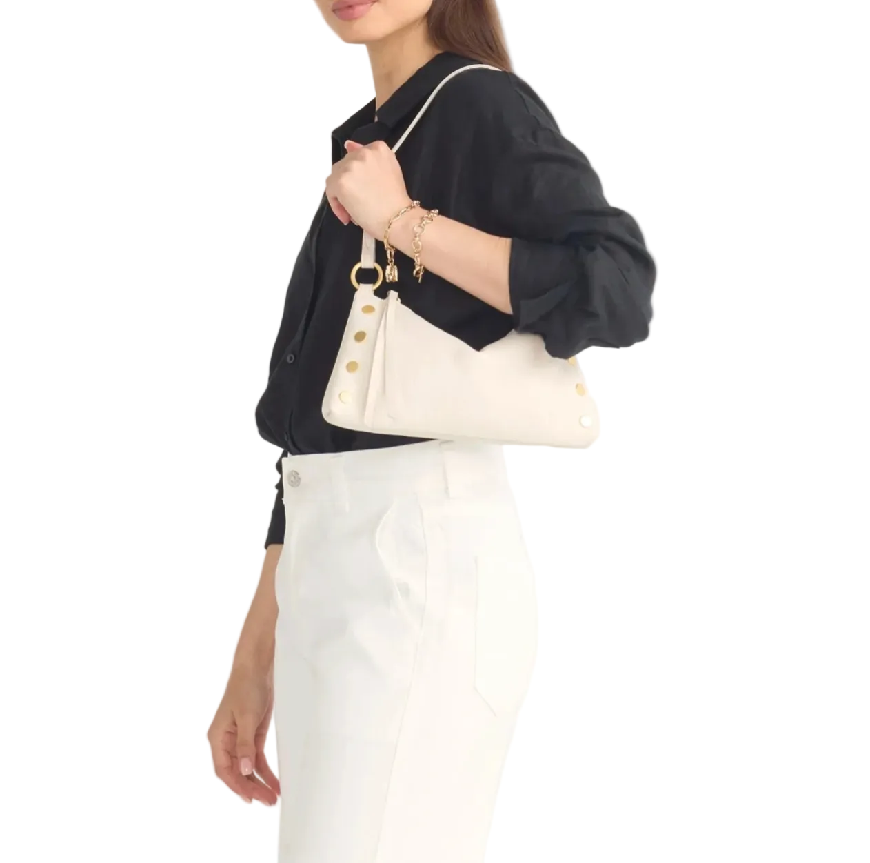 Person holding a cream handbag with gold buttons on a white background