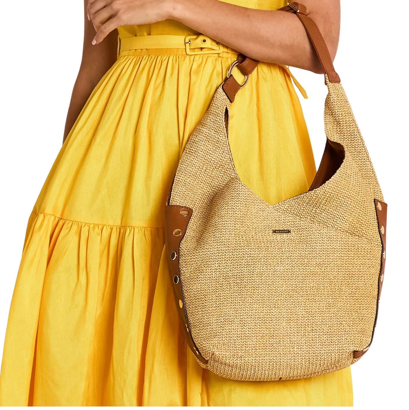 Woman wearing a yellow dress with a textured beige handbag on a white background