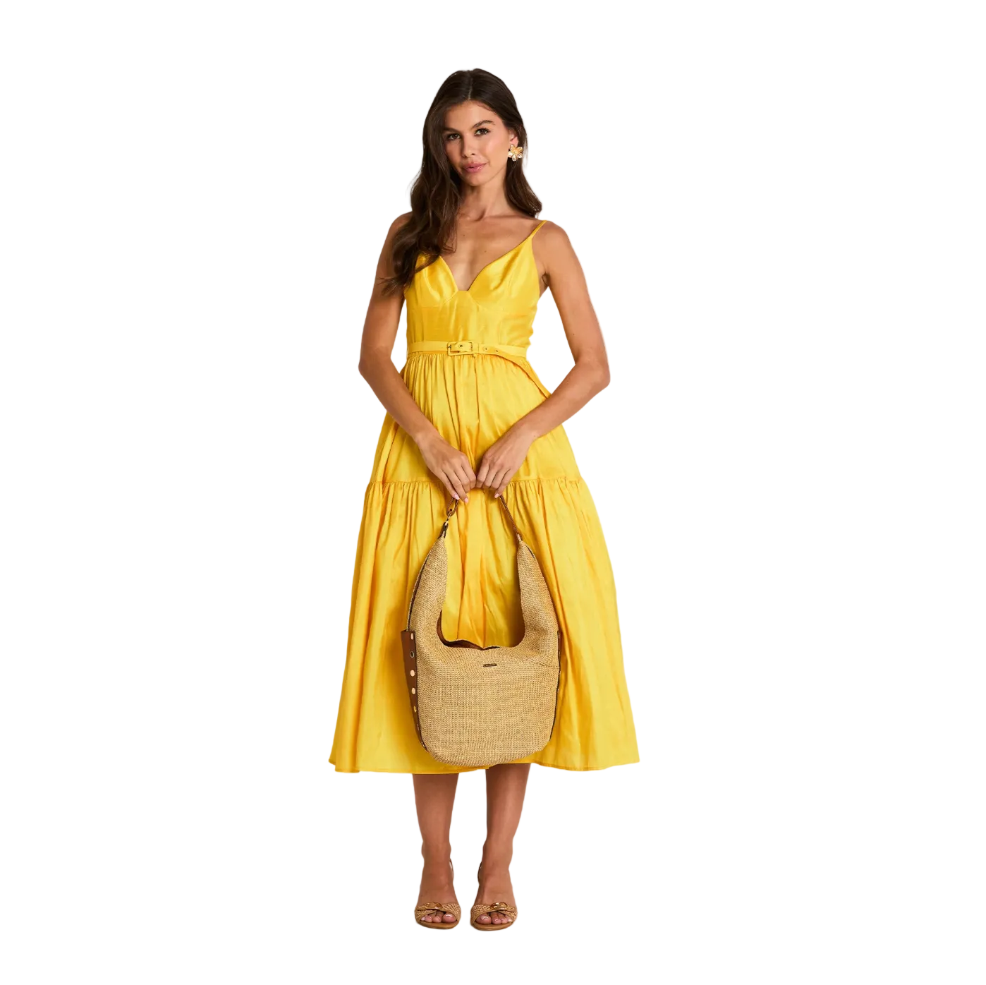 Woman in a yellow dress holding a beige bag on a white background
