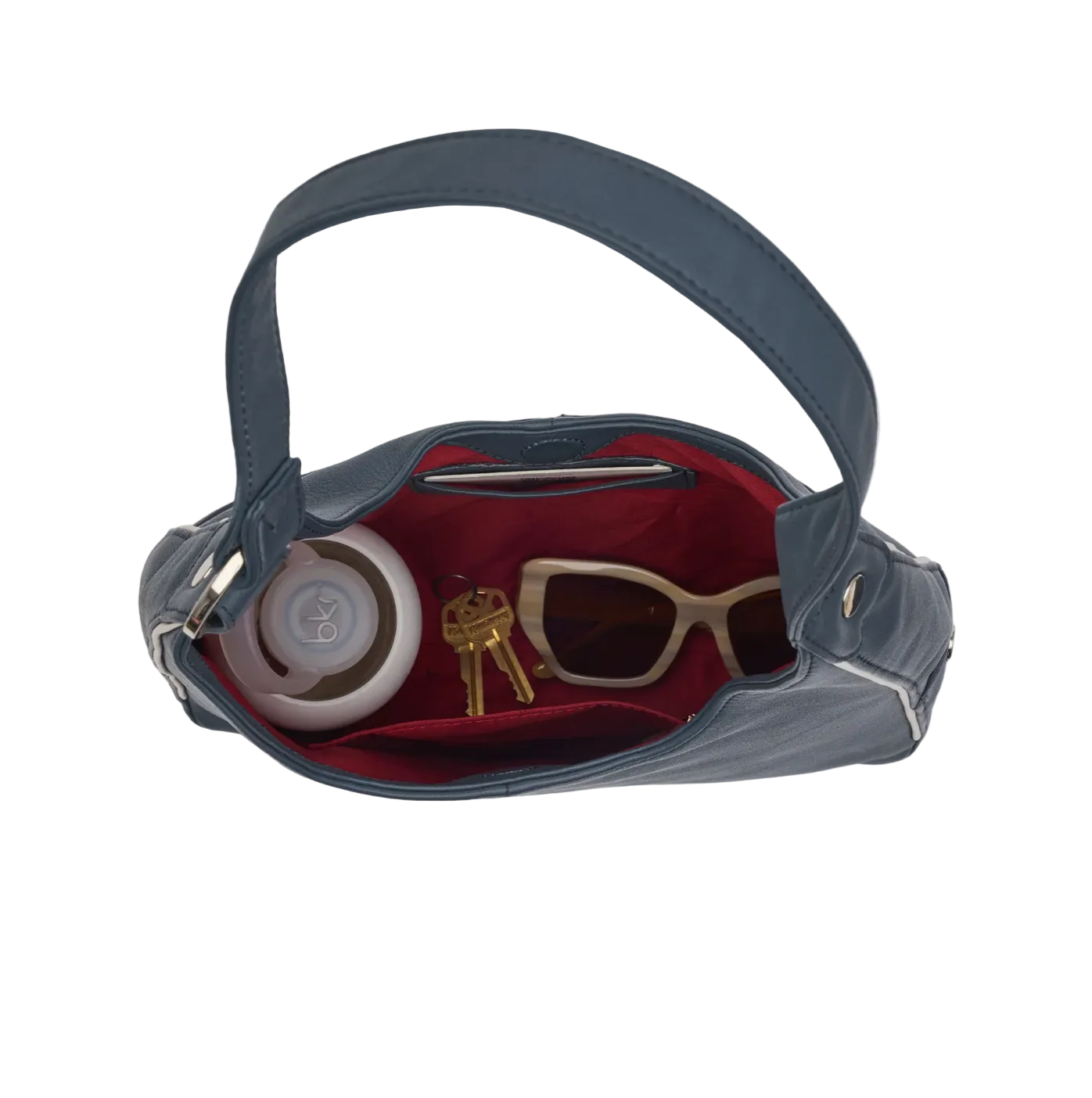 Blue handbag with sunglasses, keys, and a container on a white background