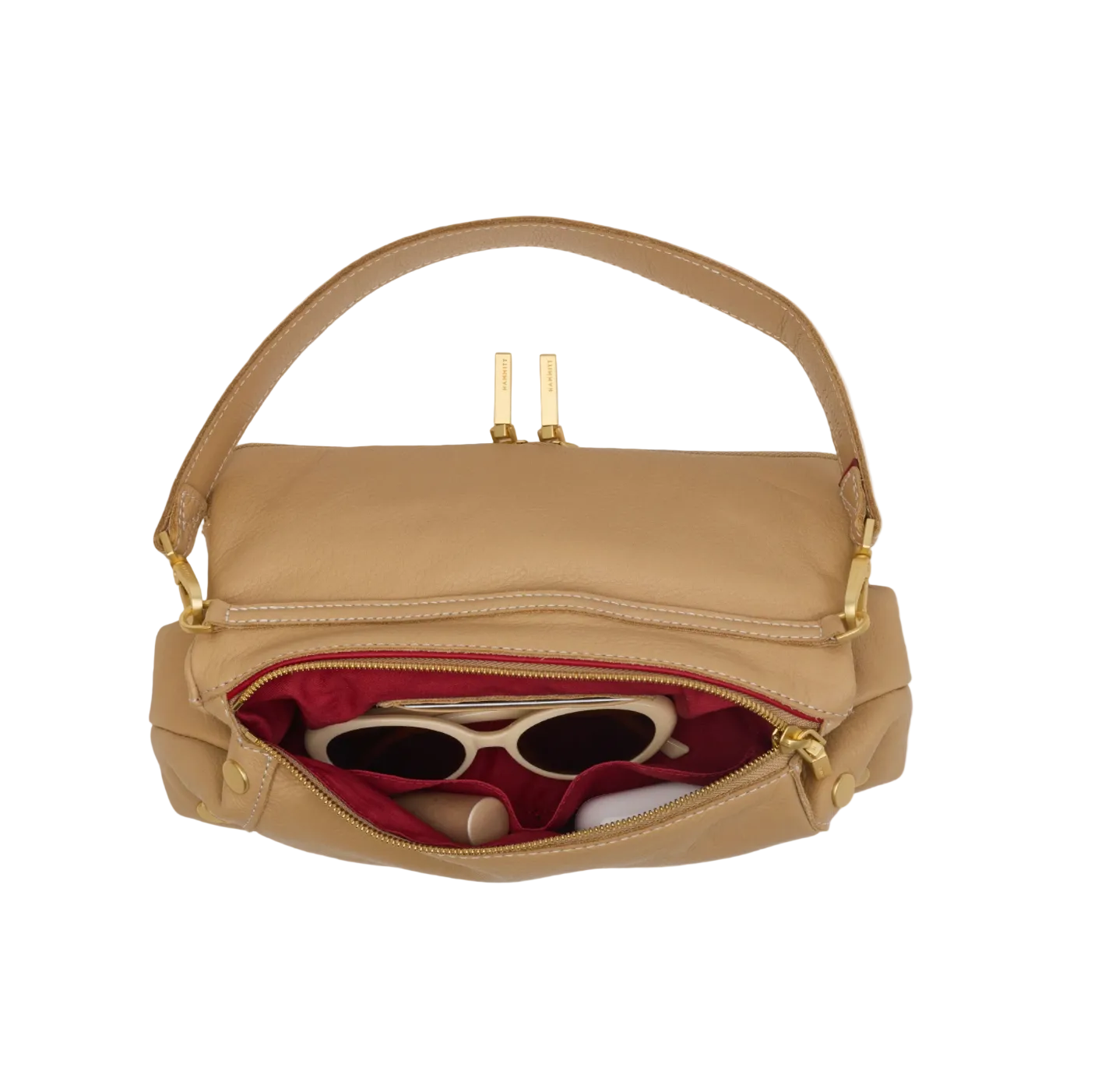 Beige handbag with sunglasses and a phone inside on a white background