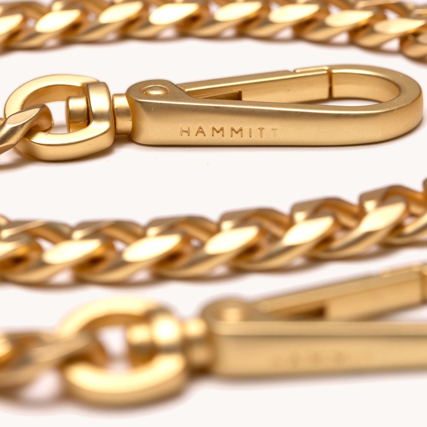 Gold chain with a clasp on a white background