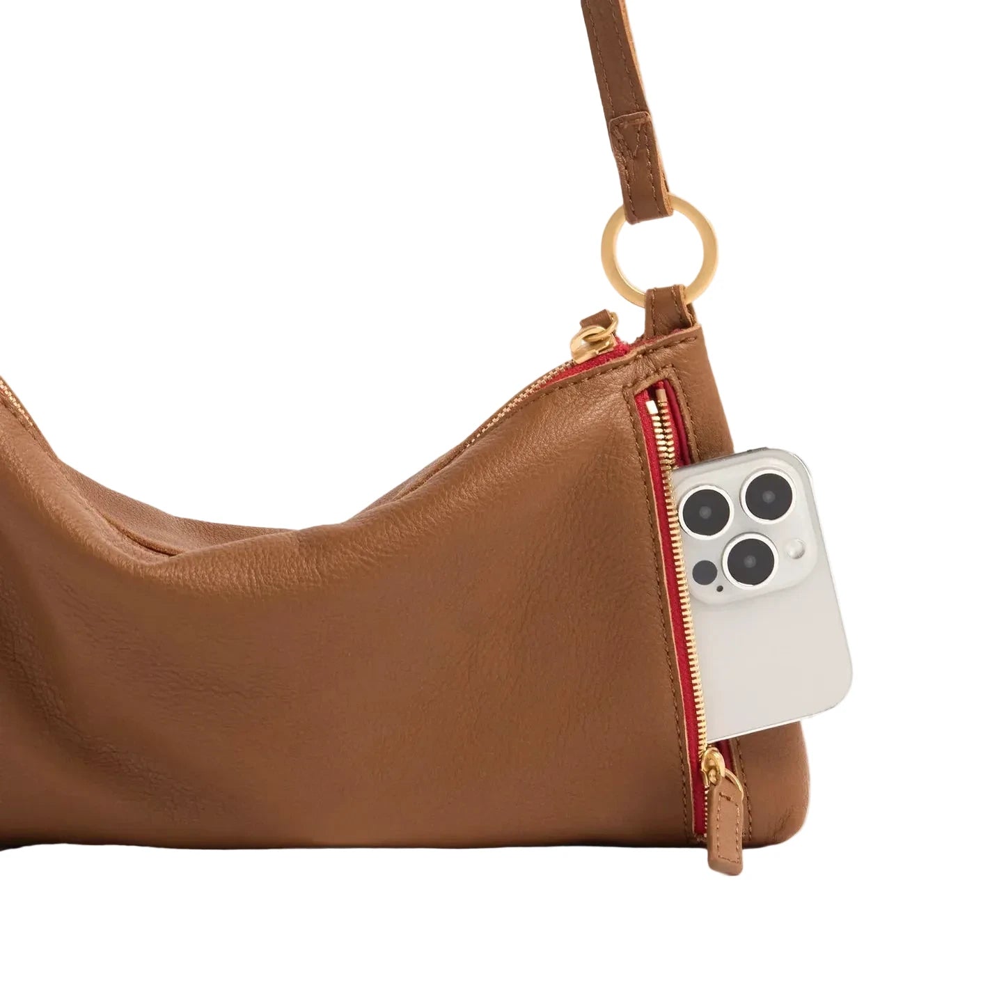 Brown leather handbag with a red zipper pocket containing a smartphone on a white background