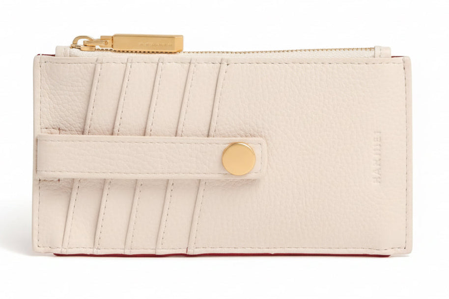 Beige wallet with gold accents on a white background